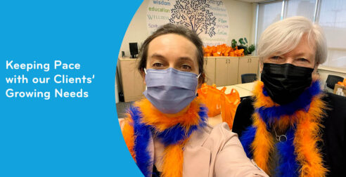 Summer update from Heather McDonald, CEO. Two women wearing mases and blue and orange feather boas